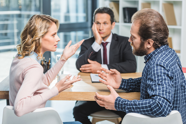 couple arguing at lawyer office